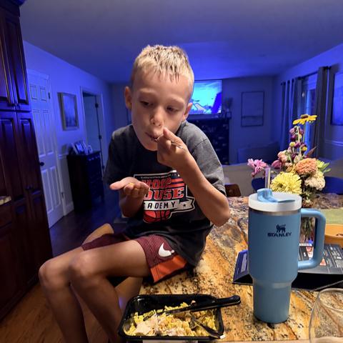 A boy enjoying a Strong Kitchen meal